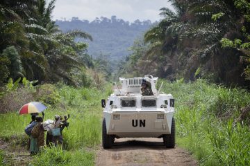 A MONUSCO APC is greeted by local residents near the front line in the Beni region where the UN is backing the FARDC in an operation against ADF militia, the 13th of March 2014. © MONUSCO/Sylvain Liechti