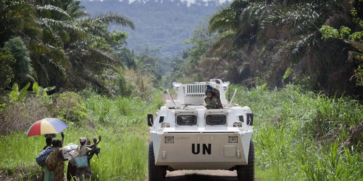 A MONUSCO APC is greeted by local residents near the front line in the Beni region where the UN is backing the FARDC in an operation against ADF militia, the 13th of March 2014. © MONUSCO/Sylvain Liechti