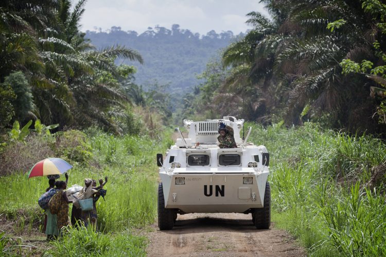 A MONUSCO APC is greeted by local residents near the front line in the Beni region where the UN is backing the FARDC in an operation against ADF militia, the 13th of March 2014. © MONUSCO/Sylvain Liechti